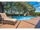 Relaxing pool area with a lounge chair and a view of the lush landscape at 2107 Westover Reserve Blvd, Windermere, FL 34786