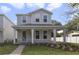 Charming two-story home featuring a welcoming front porch, manicured lawn, and modern architectural design at 2138 Forest Cir # 32, Orlando, FL 32803