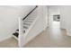 Bright foyer showcasing a classic staircase with white railings and contrasting dark treads, leading to the upper level at 2138 Forest Cir # 32, Orlando, FL 32803