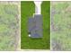 Close aerial shot of the roof, driveway, and surrounding green space of this property at 95 Malauka Place Trak, Ocklawaha, FL 32179