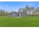 Spacious backyard with lush green grass and privacy at 95 Malauka Place Trak, Ocklawaha, FL 32179