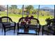 Relaxing enclosed patio with wicker furniture and view of backyard at 517 Cardinal Dr, Kissimmee, FL 34759