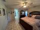 Main bedroom with a large bed, dresser, and en-suite bathroom at 517 Cardinal Dr, Kissimmee, FL 34759