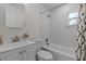 Modern bathroom with sleek white tiles, a shower-tub combo, and a minimalist design at 618 S Lakeland Ave, Orlando, FL 32805