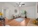 Inviting living room featuring a ceiling fan, neutral decor, and a bright front door at 618 S Lakeland Ave, Orlando, FL 32805