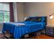 Bedroom with wood floors features a large window and a cozy nightstand at 7250 Westpointe Blvd # 1035, Orlando, FL 32835