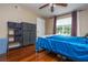 Bedroom features wood floors, a large window, a storage shelf and storage drawers at 7250 Westpointe Blvd # 1035, Orlando, FL 32835