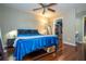 Spacious bedroom boasts hardwood floors, a ceiling fan, and walk-in closet for ample storage at 7250 Westpointe Blvd # 1035, Orlando, FL 32835