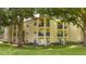 Exterior view of tan condos featuring patios and blue railing at 7250 Westpointe Blvd # 1035, Orlando, FL 32835