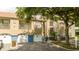 Exterior of condo with garages and colorful landscaping at 7250 Westpointe Blvd # 1035, Orlando, FL 32835