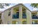 Beige condo exterior featuring a blue balcony railing at 7250 Westpointe Blvd # 1035, Orlando, FL 32835