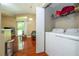 Functional laundry area features a modern washer and dryer near a cozy living space with sliding glass doors at 7250 Westpointe Blvd # 1035, Orlando, FL 32835