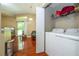Bright laundry area featuring a white washer and dryer, with shelving for storage and household supplies at 7250 Westpointe Blvd # 1035, Orlando, FL 32835