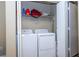 Practical laundry area with side by side washer and dryer hookups and convenient overhead storage shelves at 7250 Westpointe Blvd # 1035, Orlando, FL 32835