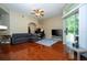 Spacious living room with hardwood flooring, balcony access, and comfortable seating at 7250 Westpointe Blvd # 1035, Orlando, FL 32835