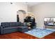 Open-concept living area featuring hardwood floors, a sectional sofa, and a workspace at 7250 Westpointe Blvd # 1035, Orlando, FL 32835