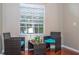 Bright sitting area with wicker furniture, turquoise cushions, coffee table, lamp, and window with blinds at 7250 Westpointe Blvd # 1035, Orlando, FL 32835