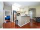 Open-concept living space boasting hardwood floors, a stainless steel refrigerator, and seamless flow throughout the home at 7250 Westpointe Blvd # 1035, Orlando, FL 32835