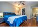 Comfortable bedroom boasts hardwood floors, a ceiling fan, and an ensuite bathroom at 7250 Westpointe Blvd # 1035, Orlando, FL 32835