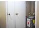 Water heater closet featuring double doors and a modern Rheem Performance water heater at 7250 Westpointe Blvd # 1035, Orlando, FL 32835