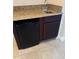 Wet bar with granite counter and dark wood cabinets at 2211 Rickover Pl, Winter Garden, FL 34787