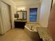 Relaxing bathroom featuring a soaking tub, vanity, and tiled floor at 2211 Rickover Pl, Winter Garden, FL 34787