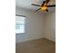 Neutral bedroom features a ceiling fan and window bringing in lots of natural light at 2211 Rickover Pl, Winter Garden, FL 34787