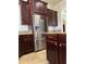 Modern kitchen showcasing stainless steel refrigerator and dark wood cabinetry at 2211 Rickover Pl, Winter Garden, FL 34787