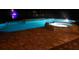 Inviting, illuminated pool and spa area at night, creating a serene and luxurious ambiance at 2211 Rickover Pl, Winter Garden, FL 34787