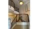 A grand staircase with dark wood railings and decorative wrought iron accents at 2211 Rickover Pl, Winter Garden, FL 34787