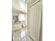 Simple bathroom with white vanity, toilet and linen closet at 3844 Eversholt St, Clermont, FL 34711