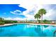 Refreshing community pool with lounge chairs and palm trees at 3844 Eversholt St, Clermont, FL 34711