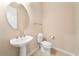 Cozy powder room with a pedestal sink, toilet, and tiled floor at 737 Alcove Dr, Groveland, FL 34736