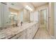 Bathroom with a large mirror, granite countertops, and modern fixtures at 737 Alcove Dr, Groveland, FL 34736