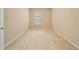 Neutral bedroom with carpet flooring and a single window with blinds at 737 Alcove Dr, Groveland, FL 34736