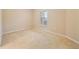 Neutral bedroom featuring carpeted floors and natural light from a window at 737 Alcove Dr, Groveland, FL 34736