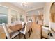 Open dining room featuring modern table and chairs next to a console table with a mirror at 737 Alcove Dr, Groveland, FL 34736