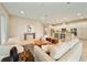 Bright, open-concept living room featuring neutral tones, modern decor, and seamless flow into the kitchen at 737 Alcove Dr, Groveland, FL 34736