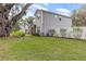 Two-story house with a side yard, white fence and landscaping at 222 Emmy Cv, Oviedo, FL 32765