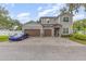 Two-story house with a double garage and a blue car parked in the driveway at 222 Emmy Cv, Oviedo, FL 32765