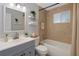 The bathroom features an integrated shower and tub, sink, and a light color scheme at 6003 Village Cir # Ge, Orlando, FL 32822