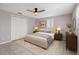This bedroom includes a ceiling fan, closet, natural light from one window, and modern decor at 6003 Village Cir # Ge, Orlando, FL 32822