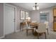 This dining room features neutral decor, a wooden table, and a view into the kitchen area at 6003 Village Cir # Ge, Orlando, FL 32822