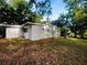Spacious backyard surrounded by lush greenery, providing privacy and a serene outdoor space at 122 Club Rd, Sanford, FL 32771