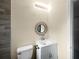 Nicely decorated bathroom with modern fixtures, including a round mirror and floating sink at 122 Club Rd, Sanford, FL 32771