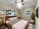 Cozy bedroom features a plush bed, soft lighting, and large windows with peaceful views at 122 Club Rd, Sanford, FL 32771
