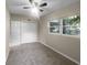 Bright bedroom with carpet, closet and a large window allowing for ample natural light at 122 Club Rd, Sanford, FL 32771