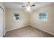 Neutral colored bedroom with two windows and a ceiling fan for natural light and comfort at 122 Club Rd, Sanford, FL 32771