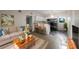Inviting living room seamlessly connects to a modern kitchen with a breakfast bar and stainless steel appliances at 122 Club Rd, Sanford, FL 32771
