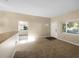 Inviting living room with carpeted floor, and white door and window frames allowing for bright natural light at 122 Club Rd, Sanford, FL 32771